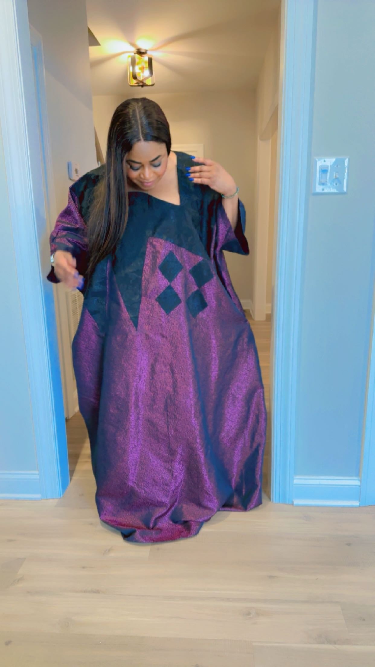 Model wearing luxurious plum and black Arewa Boubou dress with geometric embroidery design.

