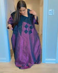 Model wearing luxurious plum and black Arewa Boubou dress with geometric embroidery design.
