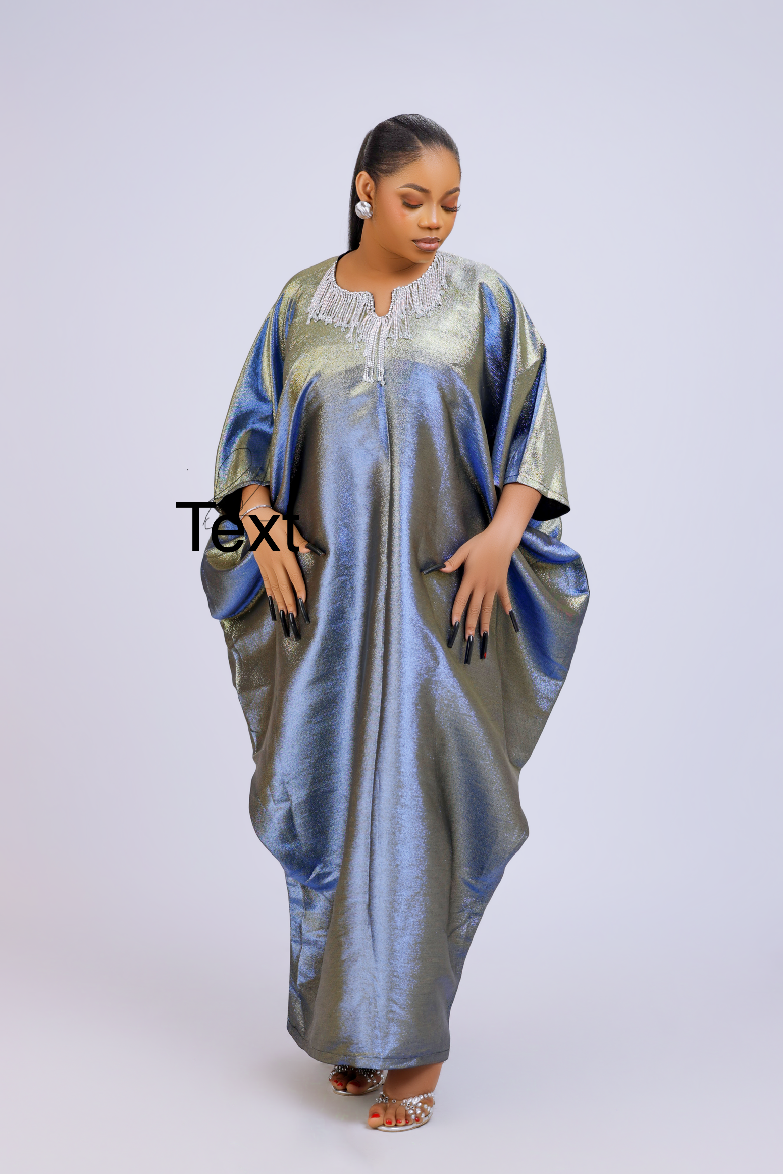 Woman wearing a shiny metallic blue-green cupped chain dress with loose sleeves and embellished neckline.
