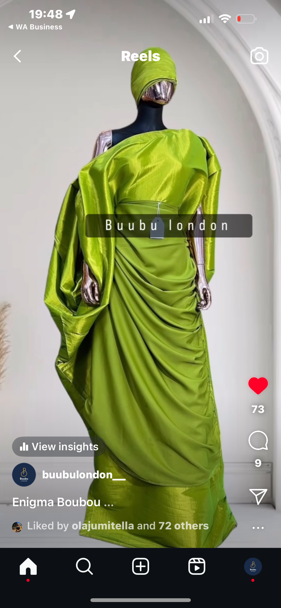 Elegant woman in a gold Show Stopper Boubou with draped detailing, posing gracefully at an outdoor event.
