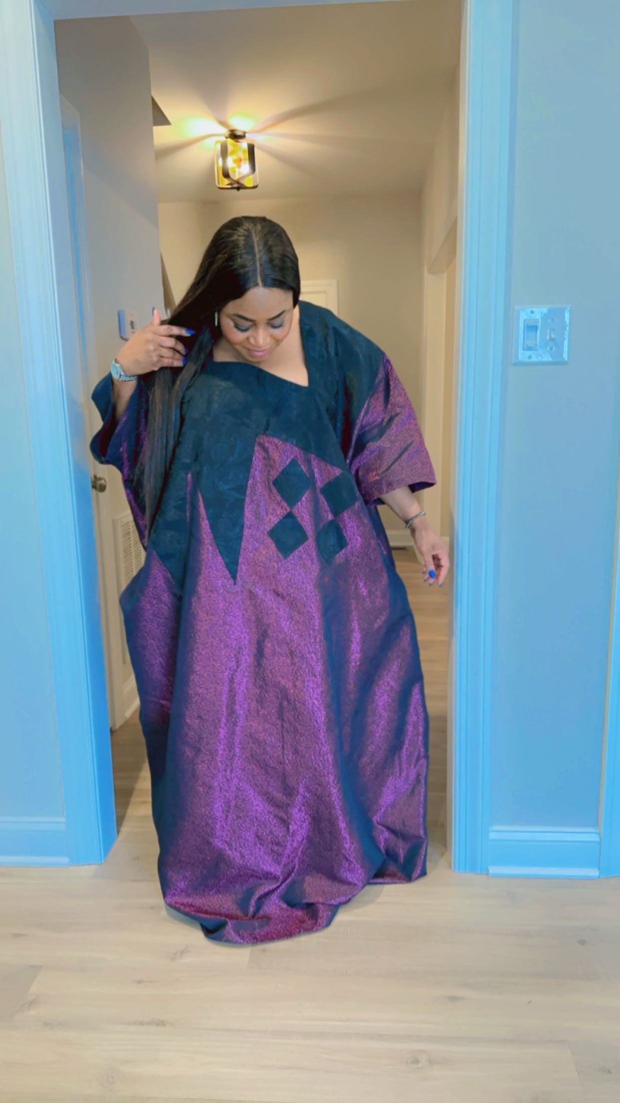 Model wearing luxurious plum and black Arewa Boubou dress with geometric embroidery design.
