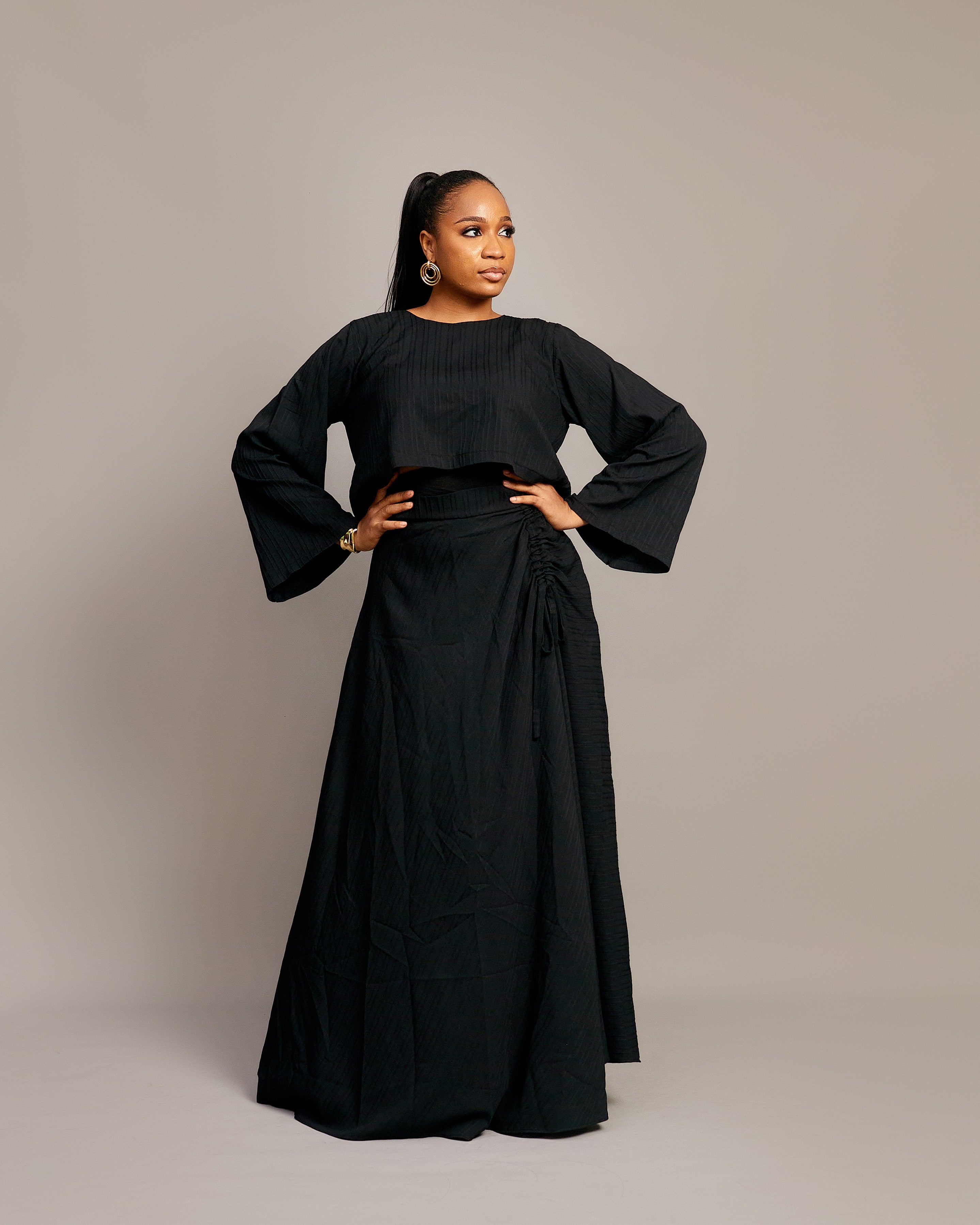  Elegant ruched maxi skirt and matching blouse in shimmering fabric.