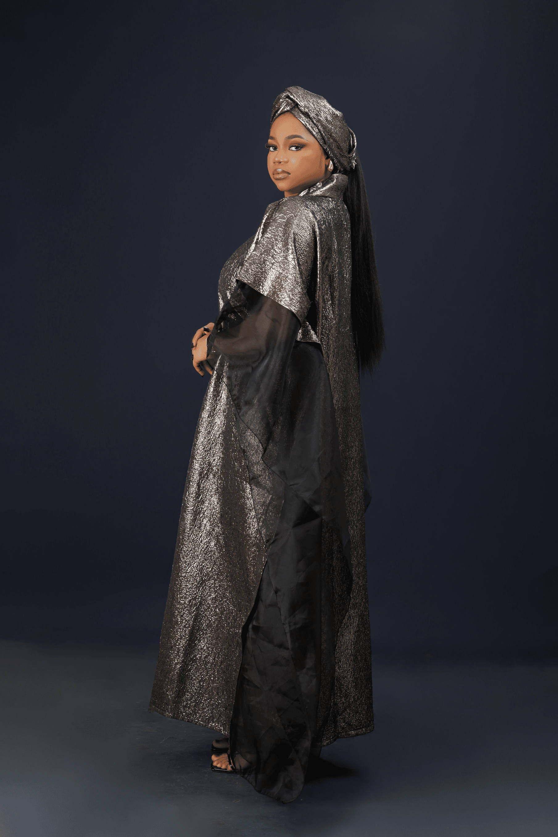 Model wearing the Royal Essence metallic kaftan dress with flowing sleeves and elegant shimmer finish.
