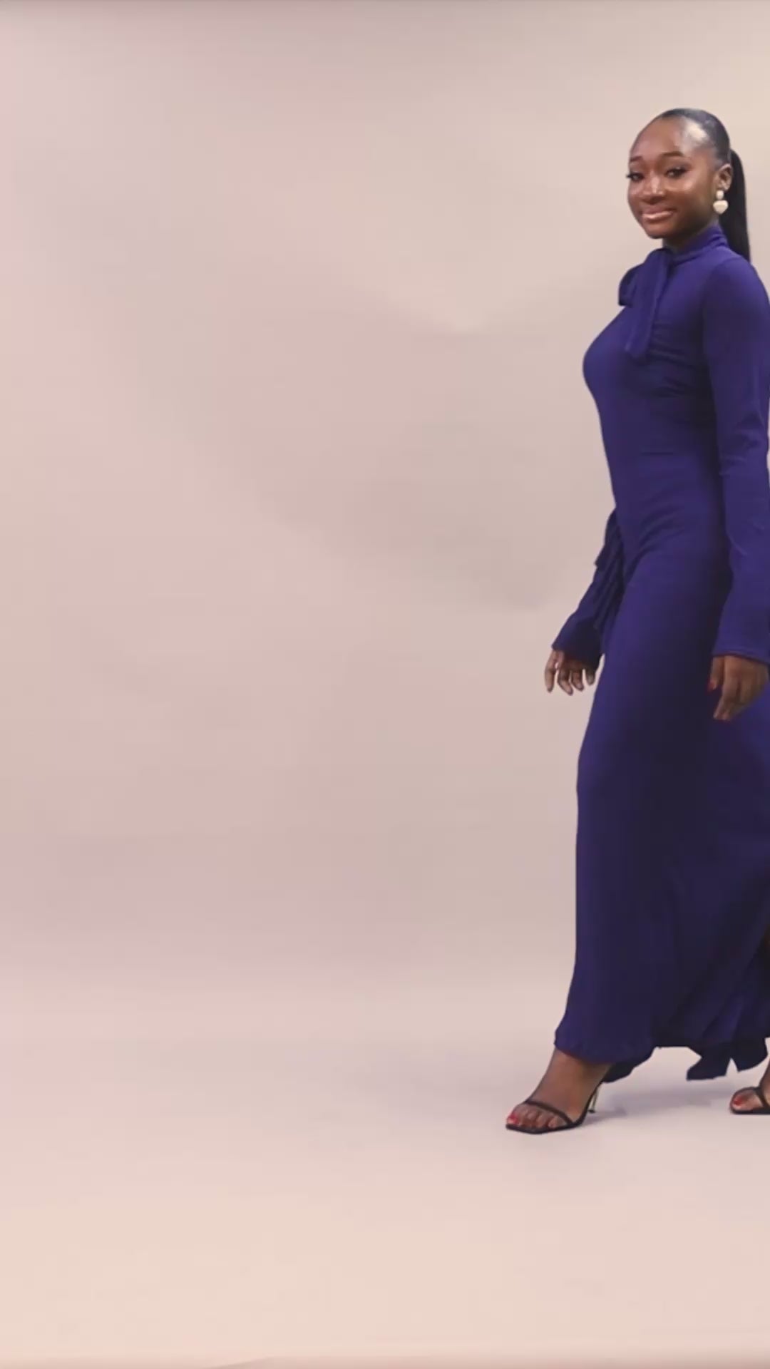  Amira Dress in navy blue with high neckline and bow tie detail.
